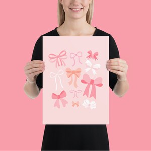May include: A pink and white print with various pink and white bows. The print features a variety of bow shapes and sizes.