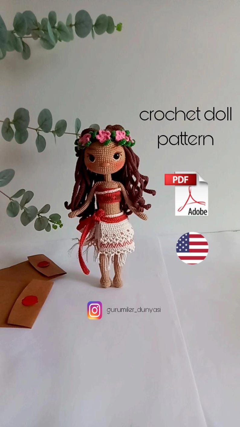 May include: Crochet doll pattern in PDF format. The doll is brown-skinned with long brown hair, wearing a red and white outfit with a flower crown. The pattern is available for download from Adobe.