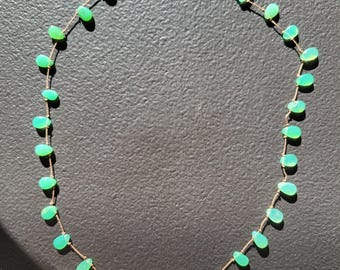Necklace of natural green chrysoprase stones in a teardrop shape, the stones knotted with silk thread. A very delicate, minimalist necklace.