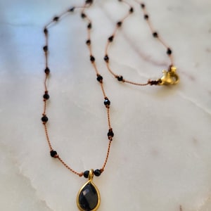Necklace made of natural black onyx stones on silk thread, black onyx pendant. Minimalist necklace made of stones on silk thread.