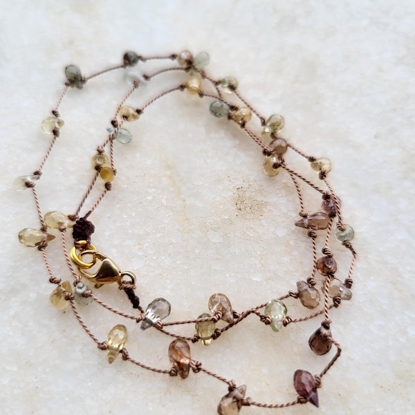 Necklace of natural multicoloured zircon stones in a warm yellow tone on natural brown silk thread. Delicate, minimalist, fine necklace.