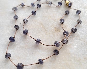 Necklace of natural blue iolite stones knotted on brown silk thread. Delicate, minimalist necklace. Necklace for women.