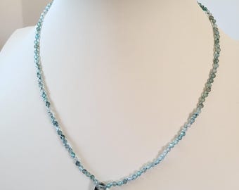 Necklace of natural blue zircon stones knotted on blue silk thread. Aquamarine pendant. Delicate minimalist necklace