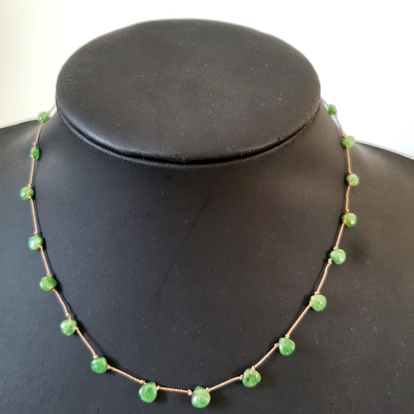 Necklace of natural green tsavorite stones in a teardrop shape, the stones knotted with silk thread. A very fine, minimalist, delicate necklace.