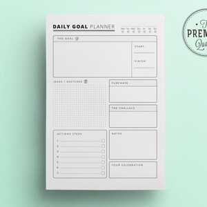 K&ouml;nnte beinhalten: Ein wei&szlig;es Daily Goal Planner-Blatt mit schwarzem Text und minimalistischem Design. Der Planer enth&auml;lt Abschnitte f&uuml;r Ziele, Ideen, Handlungsschritte und Notizen. Eine kreisf&ouml;rmige Grafik mit dem Text "The Premium Quality" befindet sich in der oberen rechten Ecke.