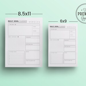 K&ouml;nnte beinhalten: Zwei wei&szlig;e Daily Goal Planner-Bl&auml;tter, eines 21,6 x 27,9 cm und das andere 15,2 x 22,9 cm, mit schwarzem Text und Umrissen. Die Planer enthalten Abschnitte f&uuml;r Ziele, Ideen, Aktionen und Notizen. Ein kreisf&ouml;rmiges "Premium Quality"-Siegel befindet sich oben rechts.