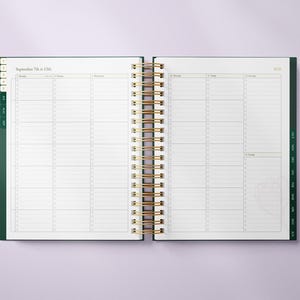 May include: Open planner with a gold spiral binding, displaying a weekly layout for September 7th to 13th, 2020. The planner has a dark green cover and page edges, with a clean, organized design. The pages are white with light gray lines.