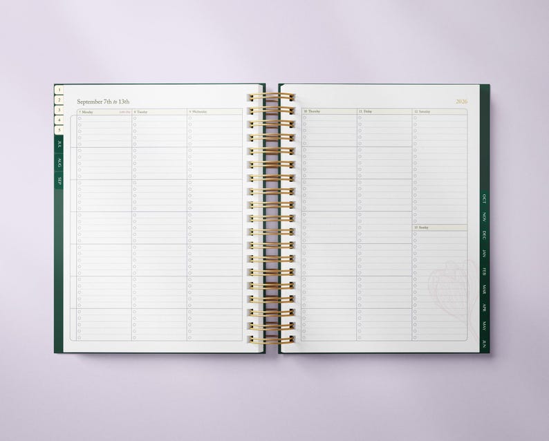 May include: Open planner with a gold spiral binding, displaying a weekly layout for September 7th to 13th, 2020. The planner has a dark green cover and page edges, with a clean, organized design. The pages are white with light gray lines.