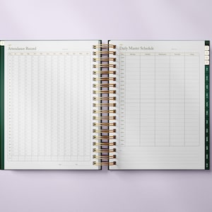 May include: Open planner with a gold spiral binding. The left page is labeled "Attendance Record" with a grid for tracking. The right page is labeled "Daily Master Schedule" with a grid for scheduling. The planner has a dark green cover.