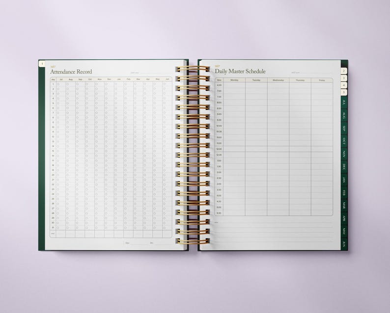 May include: Open planner with a gold spiral binding. The left page is labeled "Attendance Record" with a grid for tracking. The right page is labeled "Daily Master Schedule" with a grid for scheduling. The planner has a dark green cover.