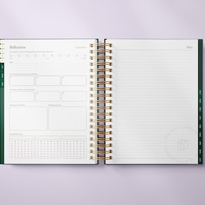 May include: Open spiral-bound planner with a green cover and gold spiral. The left page features sections for reflections and a calendar, while the right page is lined for notes. The text "Reflections" and "September" are visible.