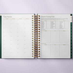 May include: Open planner with a gold spiral binding and green cover. The left page displays a yearly overview with a grid layout. The right page features semester learning goals with checklists and space for notes. Tabs along the side indicate months.