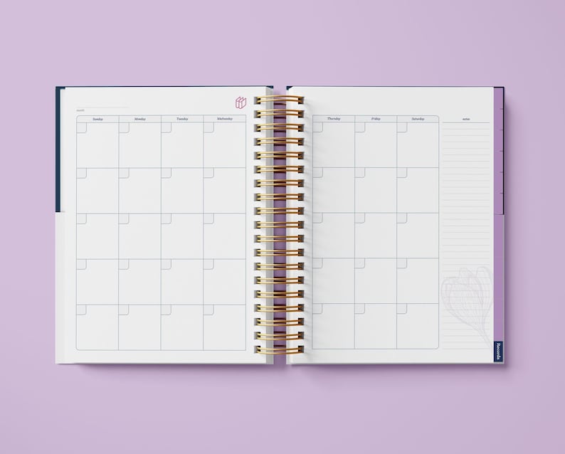 May include: An open, spiral bound planner with a blue and purple cover. The planner has a weekly layout with a notes section on the right side. The planner has a gold spiral binding.