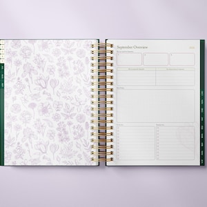 May include: Open planner with a gold spiral binding. The left page features a white background with a lavender floral pattern. The right page displays a "September Overview" with sections for notes and to-do lists. The planner has green accents.