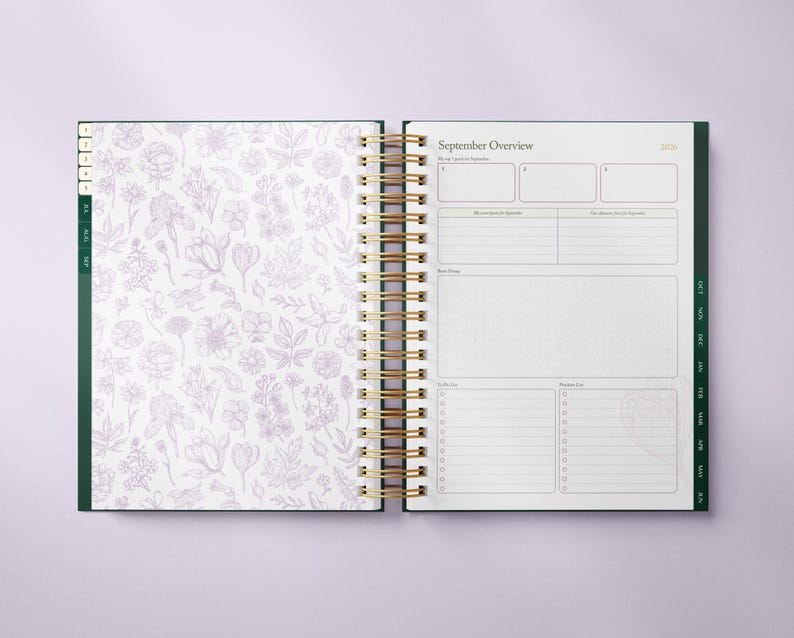 May include: Open planner with a gold spiral binding. The left page features a white background with a lavender floral pattern. The right page displays a "September Overview" with sections for notes and to-do lists. The planner has green accents.