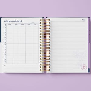 May include: An open daily planner with a blue cover and gold spiral binding. The left page has a daily master schedule with columns for each day of the week. The right page is blank with lined paper and the word "Notes" at the top.