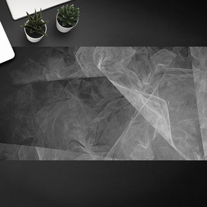 以下が含まれることがあります： 黒と白の抽象的なデザインで、微妙なグレーの背景があります。デザインは、重なり合った線と形が、動きと奥行きを感じさせます。