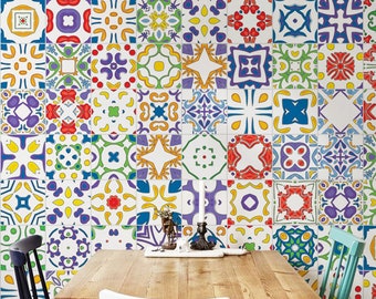 May include: A wooden dining table with four chairs set against a wall covered in colorful patterned tiles. The table has a light wood finish and the chairs are in black, white, and teal.