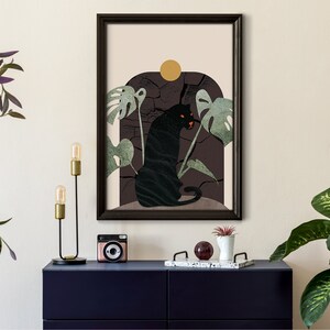 May include: A framed print with a black panther sitting in a jungle scene. The panther is surrounded by green leaves and a yellow sun. The background is a dark brown color.