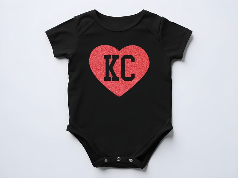 May include: Black baby onesie with a red heart that says "KC" in black letters.
