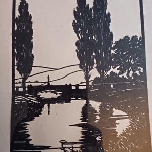 May include: Black and white woodcut print of a landscape with a river, bridge, and trees. The trees are tall and slender, and the river is winding. The bridge is a simple wooden structure.