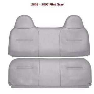 May include: Two-piece set of light gray car seat covers. The top piece has two headrest sections and a center back section. The bottom piece is a single, rectangular seat cover. The text "2003 - 2007 Flint Gray" is at the top.