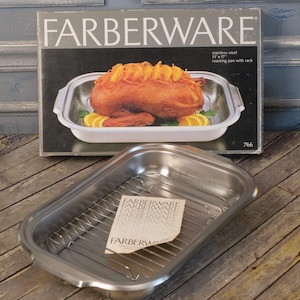 May include: Stainless steel Farberware roasting pan with rack. The box shows a roasted duck with orange slices. The pan measures 11" x 17". The pan is silver and has a removable rack. The box has the Farberware logo.