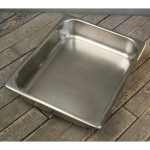 May include: A stainless steel rectangular food pan with rounded corners. The pan has a smooth, reflective surface and is designed for commercial food service. The pan is empty and ready for use.