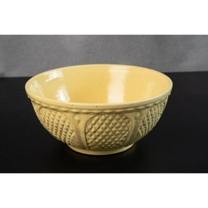 May include: A yellow ceramic mixing bowl with a textured pineapple design.