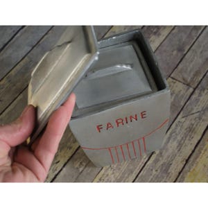 May include: A set of three ceramic mugs with a speckled, matte finish in cream, light grey, and dark grey. Each mug has a simple, minimalist design and a rounded handle.