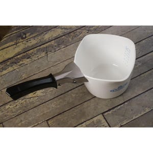 May include: White square-shaped serving dish with a metal handle and a black grip. The dish has a blue floral design and a small blue dotted pattern. The handle is attached to the side of the dish.
