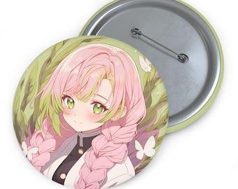 May include: A round button featuring an anime-style illustration of a character with pink hair and green eyes. The background is a light green with leaves and white butterflies. The button has a metal pin back.