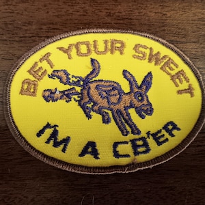 May include: A yellow embroidered patch with a brown donkey and the text "Bet Your Sweet I'm A CBer".