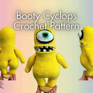 Könnte beinhalten: Ein Häkelmuster für ein gelbes Amigurumi-Spielzeug mit einem Auge, genannt "Booty Cyclops".