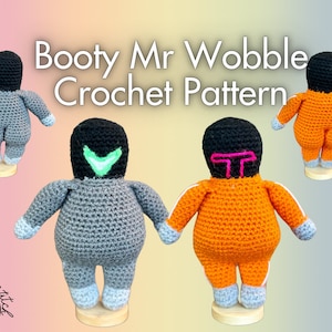 May include: Crochet pattern for a gray and orange amigurumi doll with the text "Booty Mr Wobble Crochet Pattern".