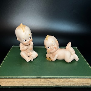 Porcelana Lefton Bisque Kewpie Babies Figurines KW913N 2-częściowy zestaw Dziecko ssące kciuk Dziecko mrugające Leżące Blond włosy Malowane ręcznie Japonia