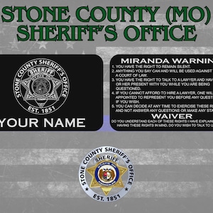 May include: A black and white Stone County Sheriff's Office badge with the text "Your Name". The image also includes a Miranda Warning and Waiver text. The badge features the Sheriff's Office seal and the text "Est. 1851".
