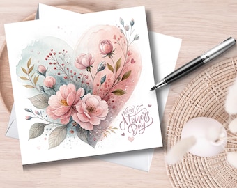 May include: A watercolour Mother's Day card with a heart design in pink and blue. The heart is decorated with pink flowers, green leaves, and the words "Happy Mother's Day" in script. A pen and a decorative item are also visible.