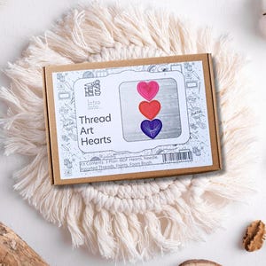 May include: A craft kit for making thread art hearts. The kit includes three wooden hearts, assorted threads, paints, a needle, and a foam brush. The box is brown with a white label that says "Intro Into Thread Art Hearts".
