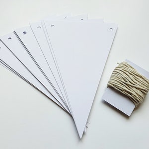 May include: A set of white triangle paper pennants with holes punched in the top corners, and a roll of twine for hanging.