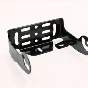 May include: A black metal bracket with multiple cut-out slots and holes. The bracket has a curved design with two circular openings on the sides. The object is likely a component for mounting or supporting another item.