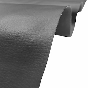 May include: Close-up of a dark grey textured fabric. The fabric has a slightly pebbled surface and is folded over on itself.