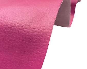 May include: Close-up of a bright pink faux leather fabric with a textured surface.