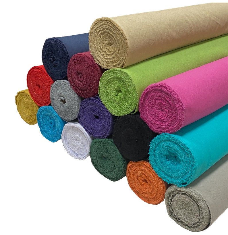 May include: A collection of 14 fabric rolls in various colors, including beige, green, pink, turquoise, and white. The rolls are stacked on top of each other, with the beige roll at the top.