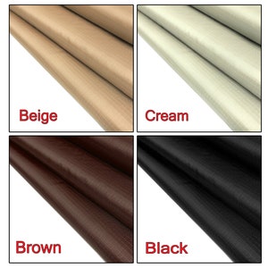 May include: Four fabric swatches in different colors: beige, cream, brown, and black. Each swatch has a textured, woven pattern.