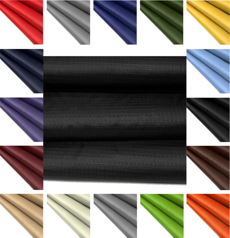 May include: A variety of colors of fabric with a grid pattern. The fabric is folded in thirds and the folds are visible. The fabric is a woven material with a smooth texture.