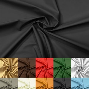 May include: A collection of fabric swatches in various colours, including gold, brown, red, green, white, grey, beige, orange, blue, and light blue. The fabric is smooth and has a slight sheen.
