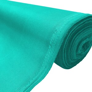 May include: A roll of turquoise fabric. The fabric is smooth and has a slight sheen.