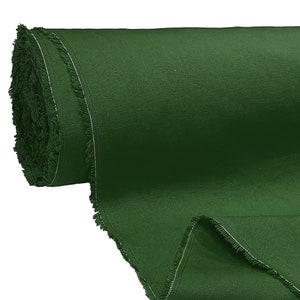 May include: A roll of dark green fabric with a fringed edge.