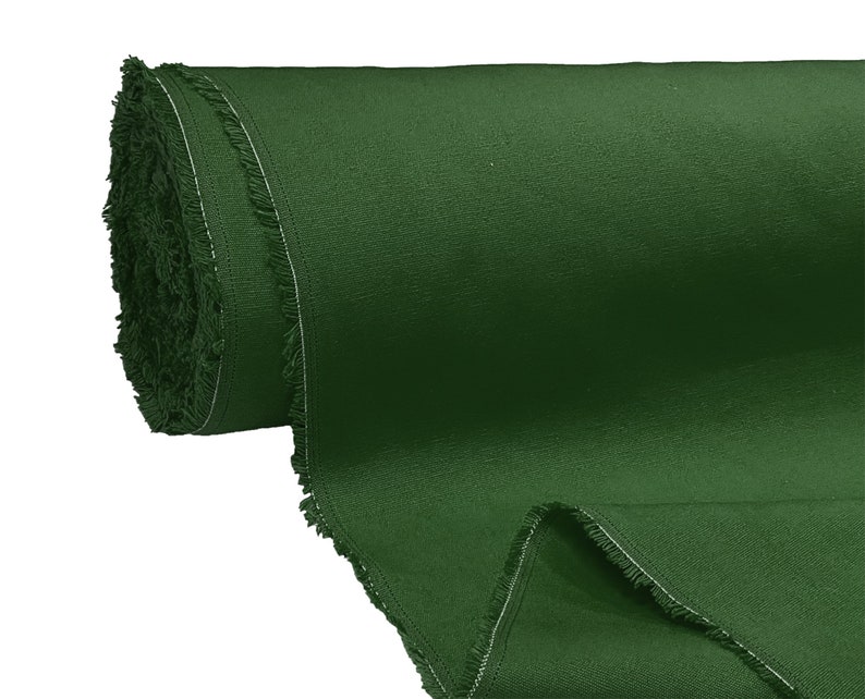May include: A roll of dark green fabric with a fringed edge.